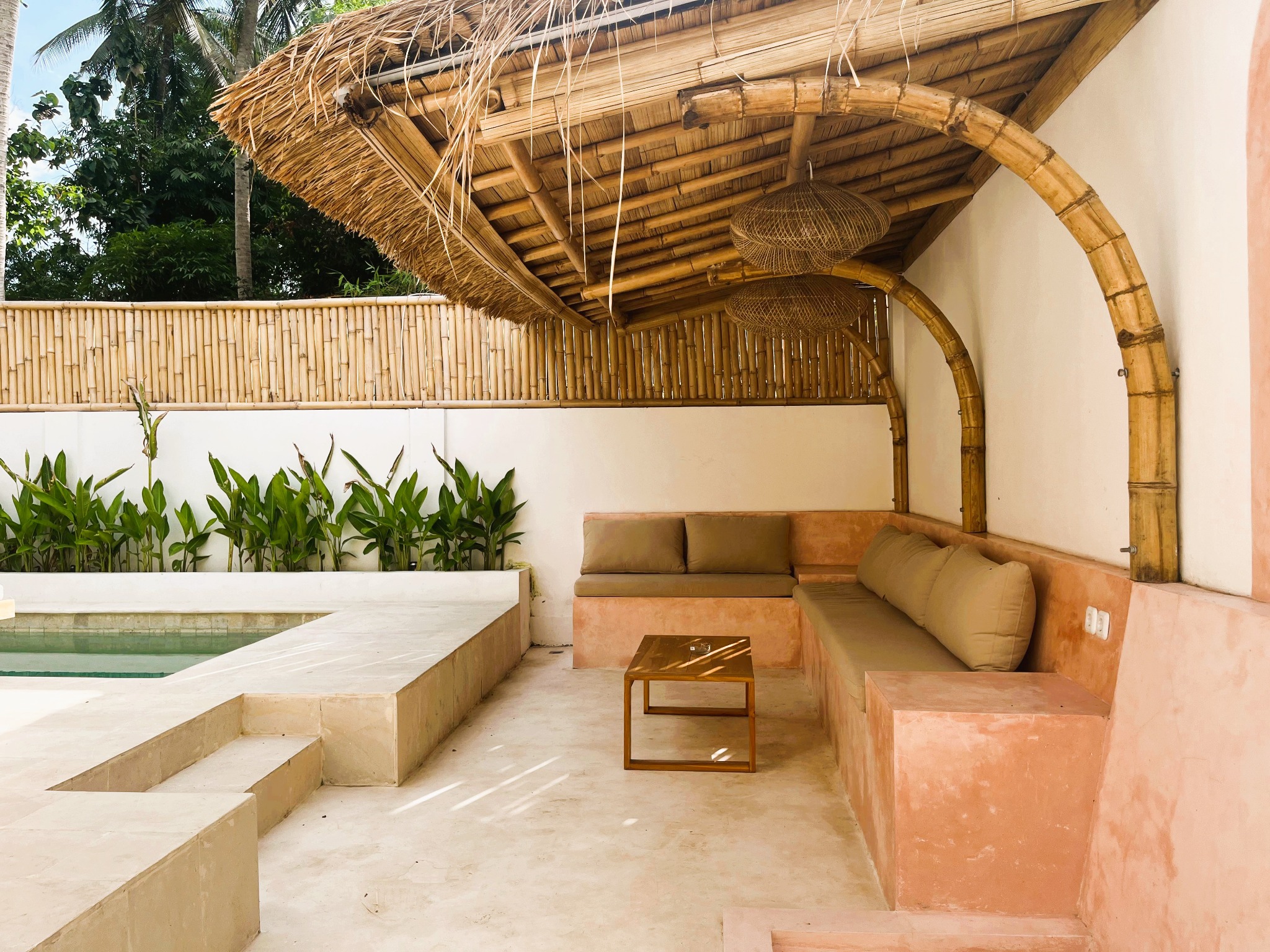 Shaded bamboo lounge beside the pool